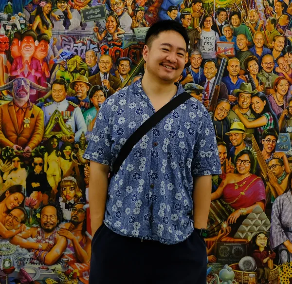 Elliot in front of a mural